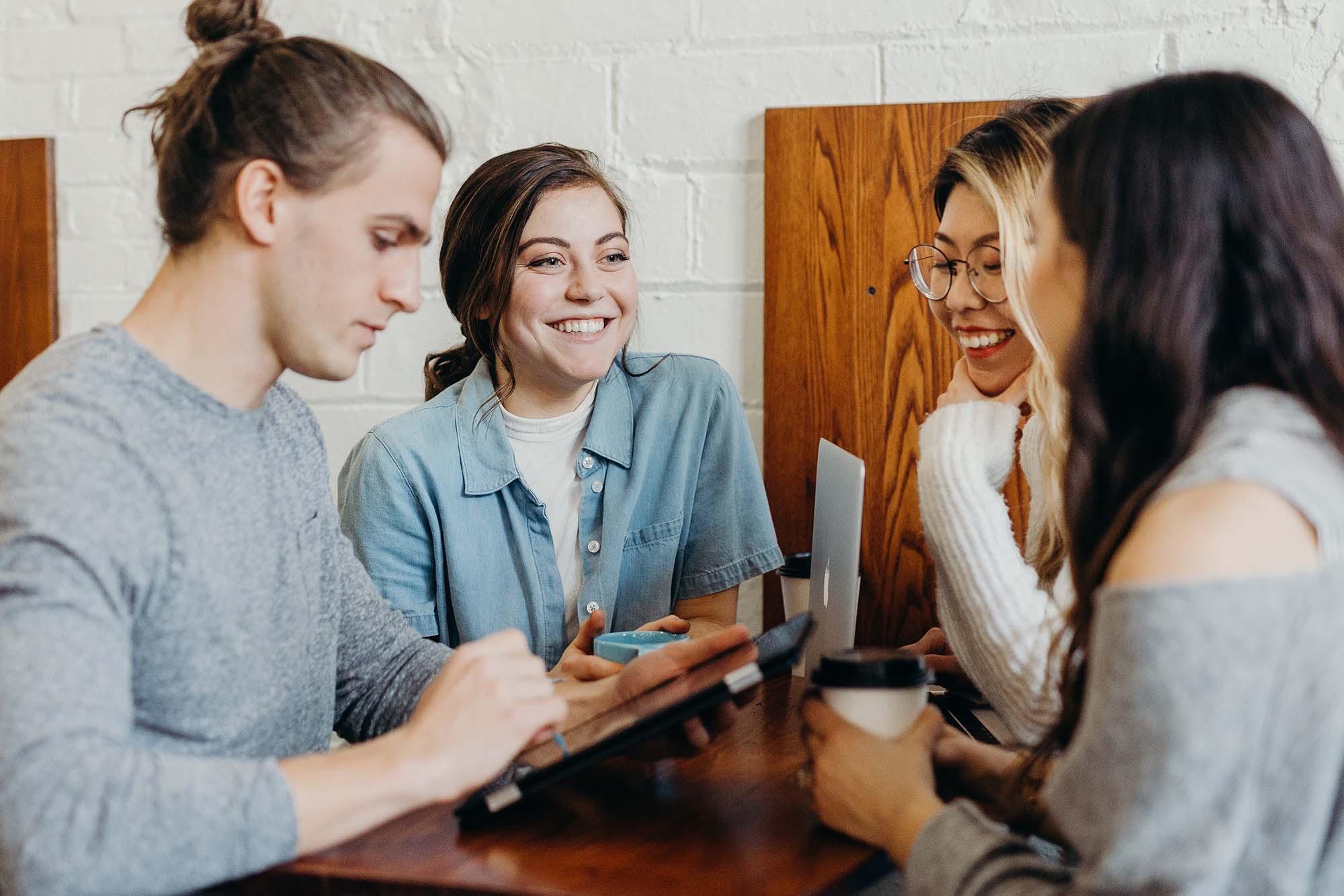 Picture of friends smiling at a coffee shop